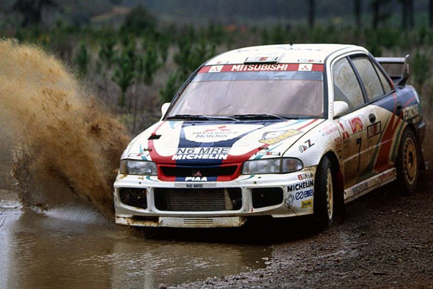 Mitsubishi Lancer Evo III racing through mud, 1996