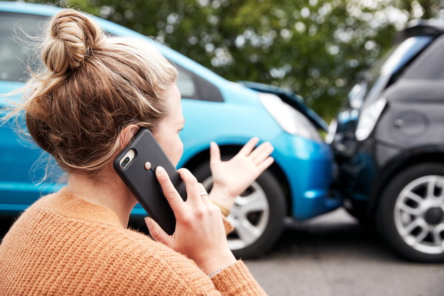 Woman Calling A Car Accident Lawyer