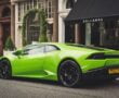 Green Lamborghini Parked In Front Of A Caffe