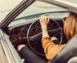Woman Steering a Wheel In A Black Vehicle