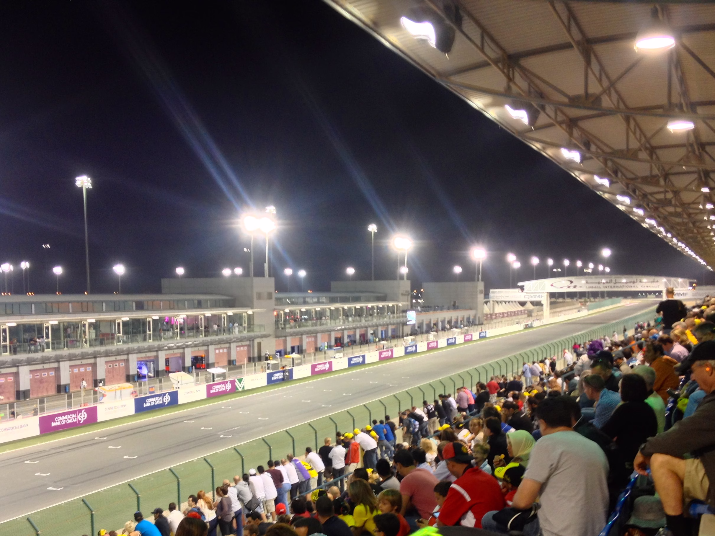 Spectators in the main grandstand overlooking the start-finish straight at Lusail International Circuit